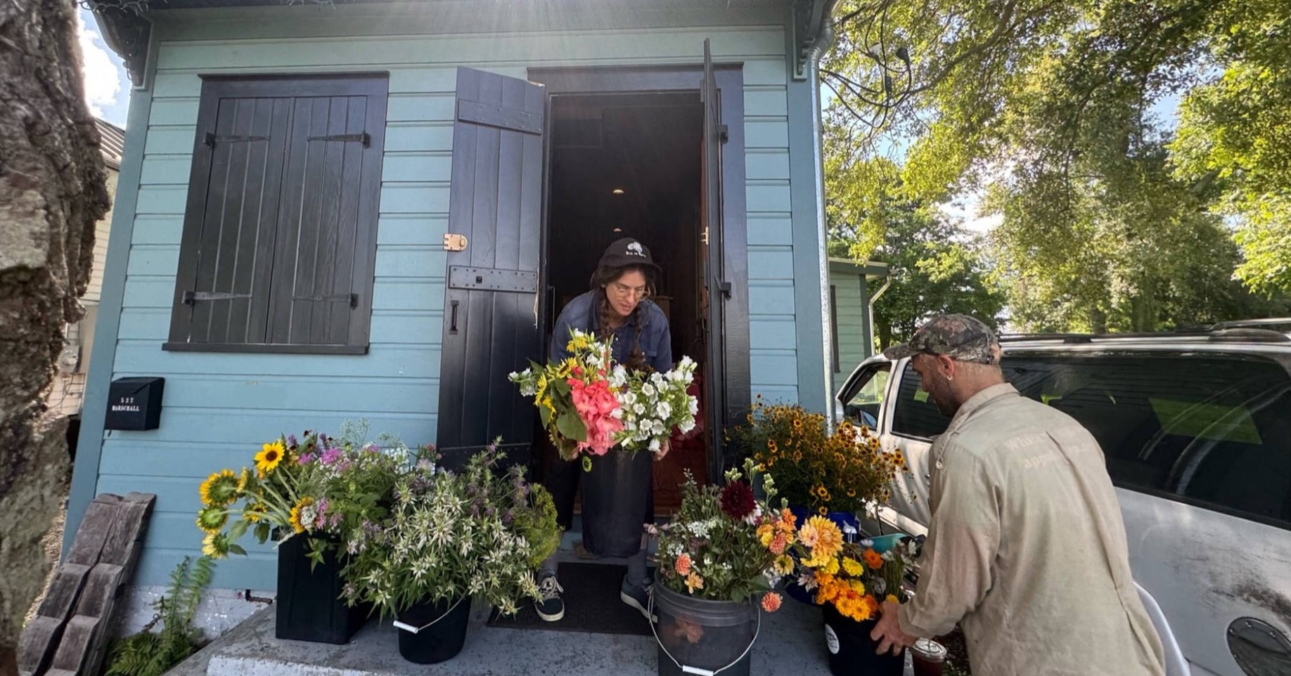 Charlotte and Chris unloading flowers on the porch